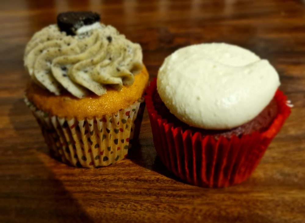 Close-up of a cookies-and-cream cupcake and a red velvet cupcake by Kakes by Grace