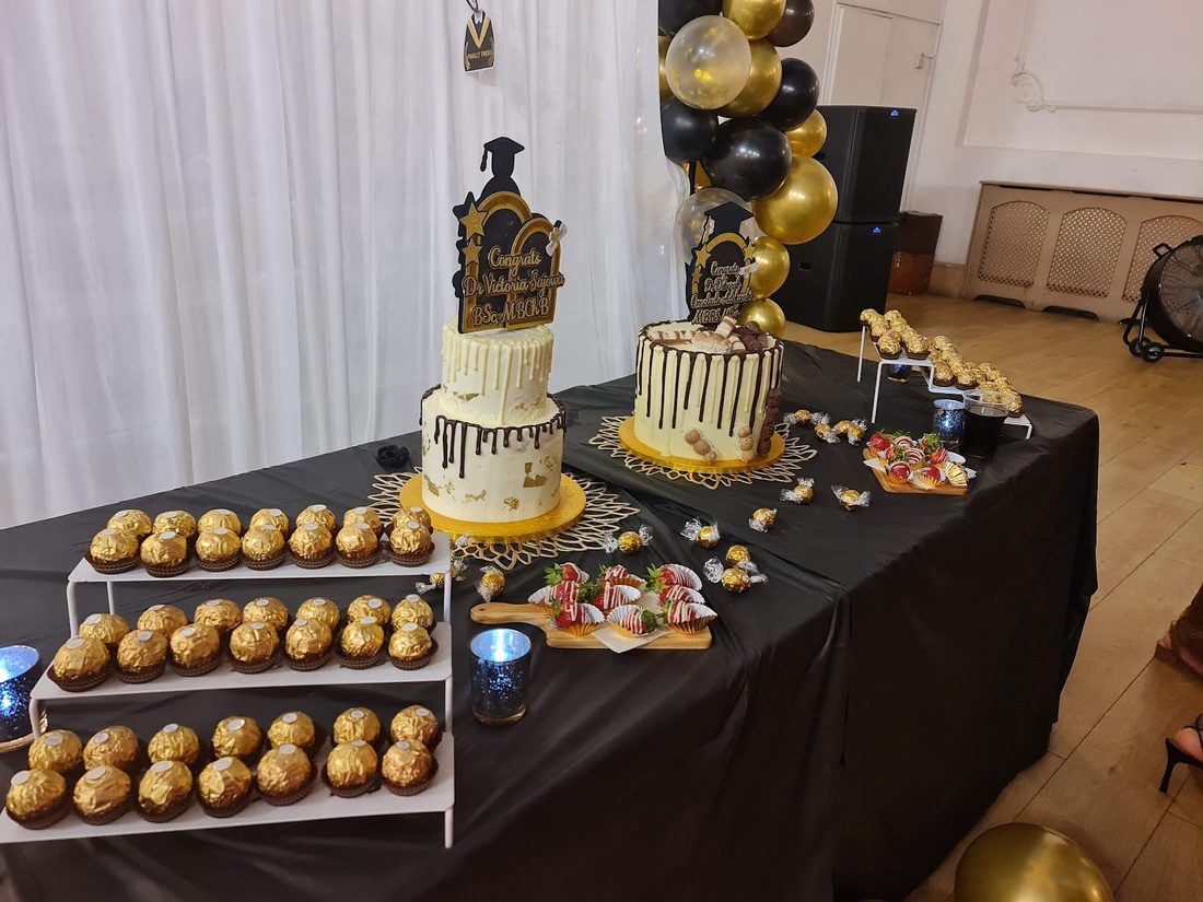 A styled graduation dessert table with drip cakes, Ferrero towers and chocolate-dipped strawberries, by Kakes by Grace